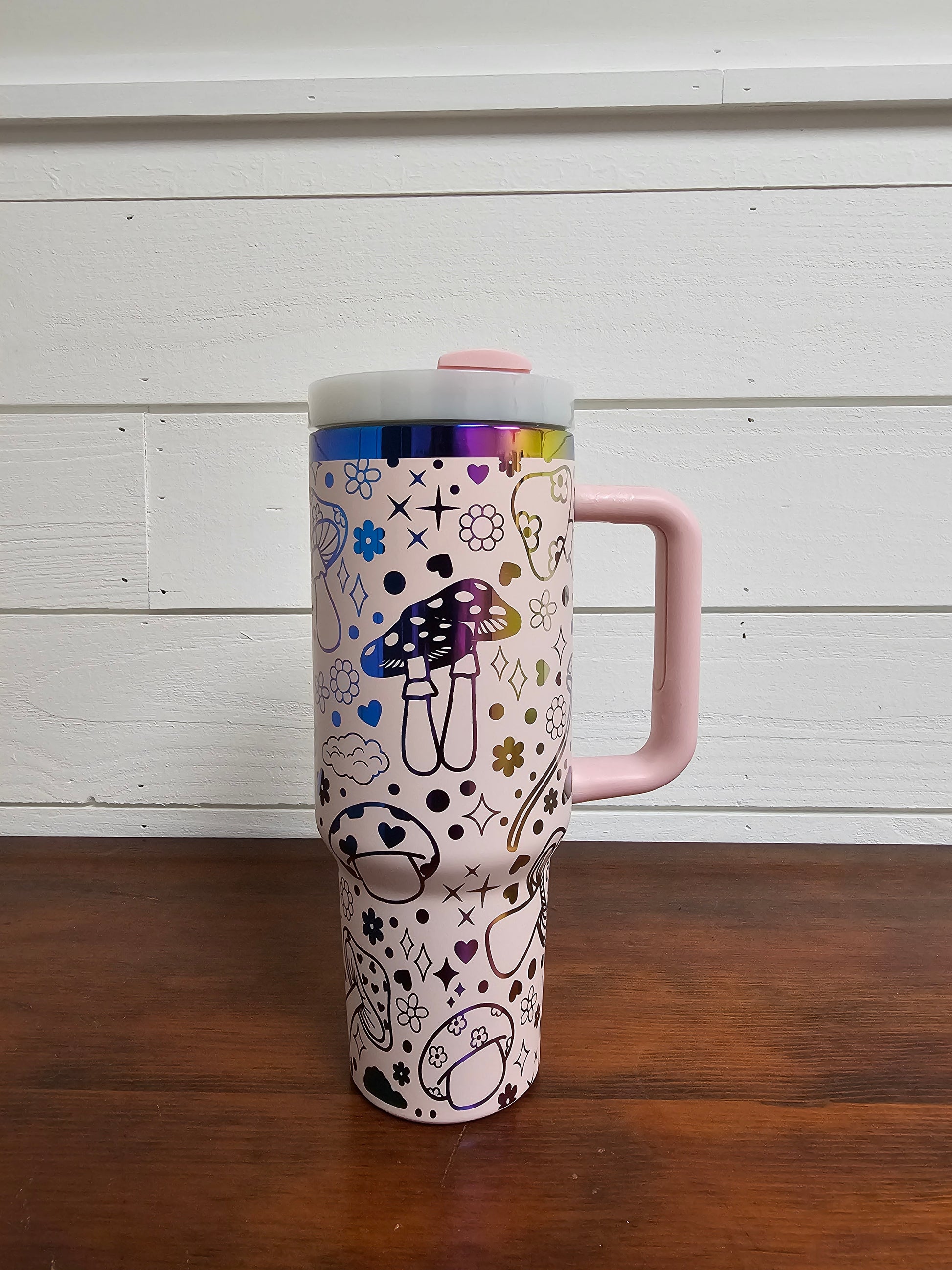40oz tumbler in pink and rainbow with magic mushroom wrap design. back view. 