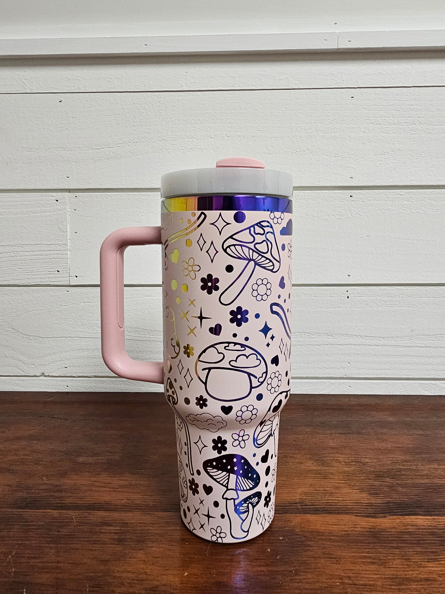 40oz tumbler in pink and rainbow with magic mushroom wrap design. Front view. 