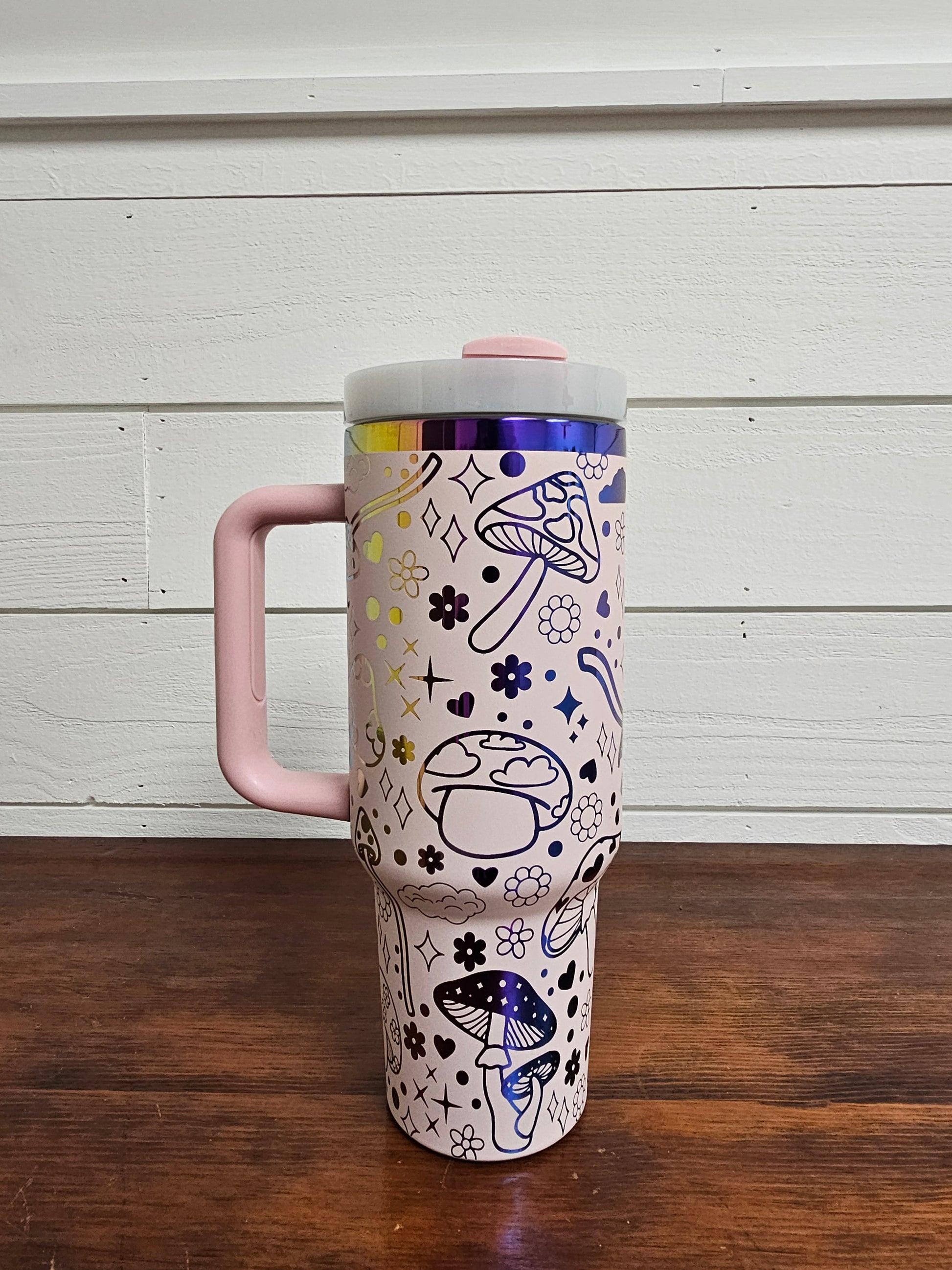 40oz tumbler in pink and rainbow with magic mushroom wrap design. Front view. 