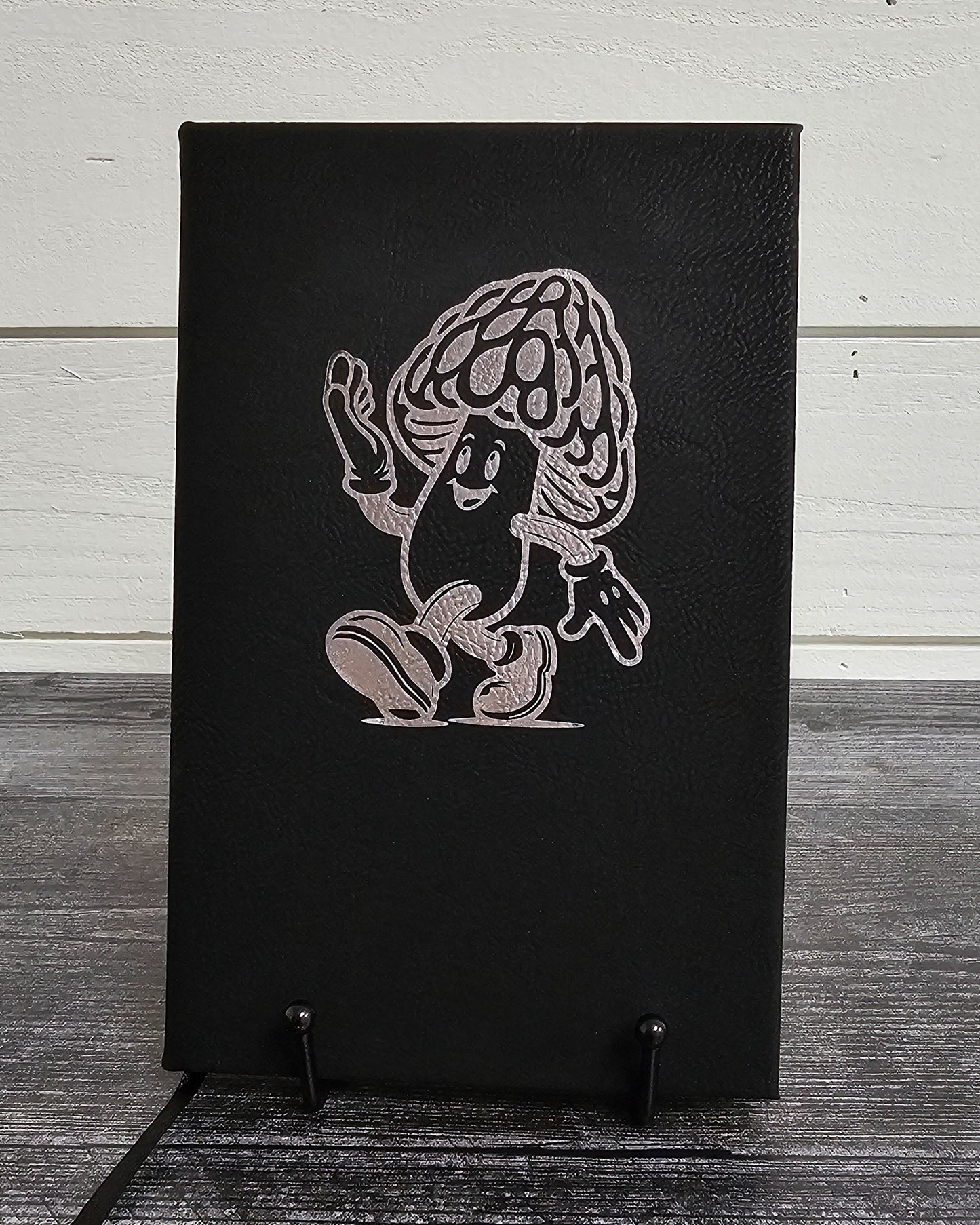 Personalized journal in black with silver engraved with fun cartoon mushroom guy design.