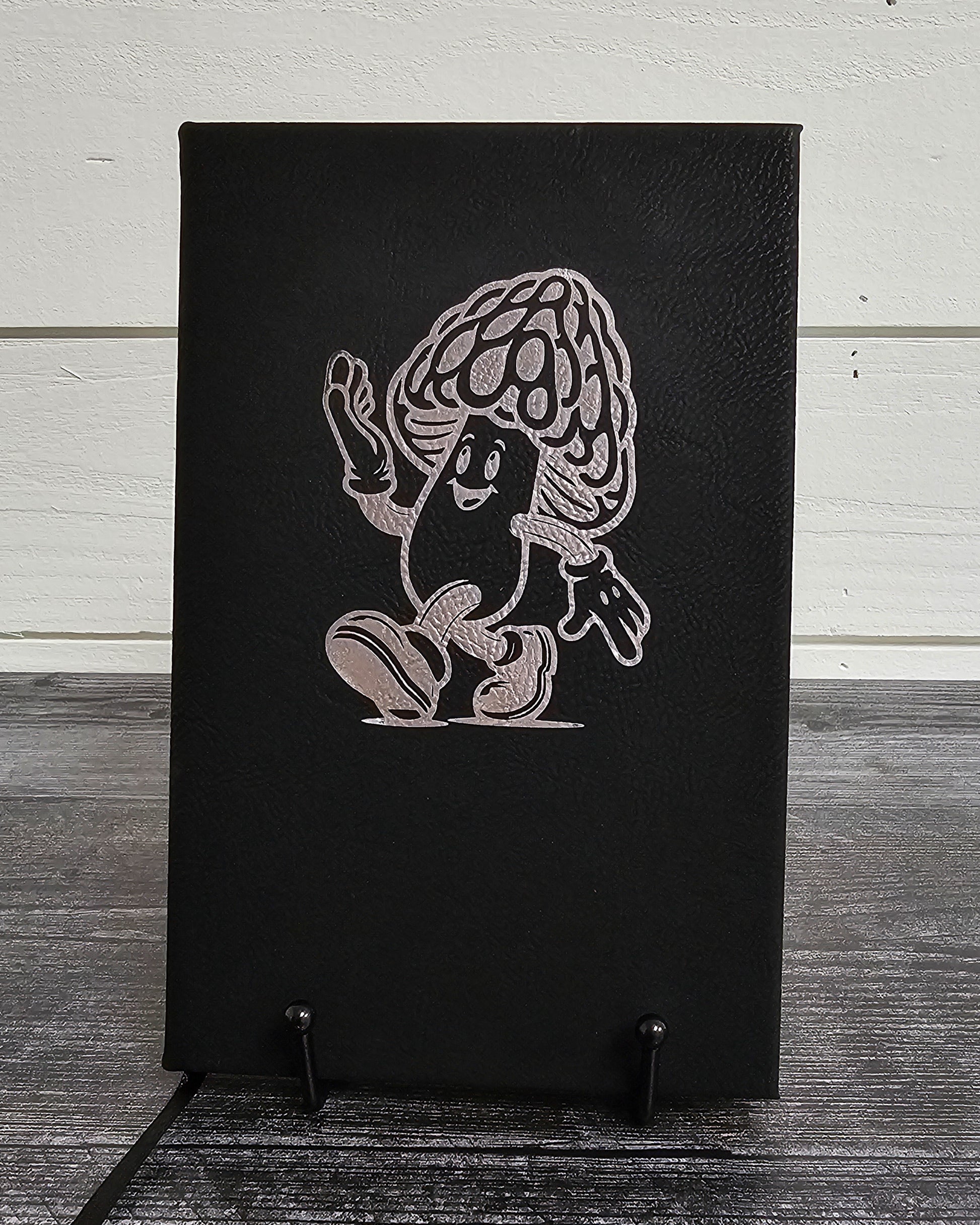 Personalized journal in black with silver engraved with fun cartoon mushroom guy design.