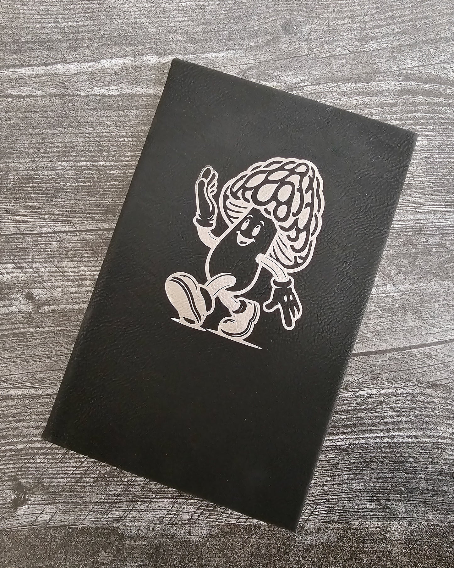 Personalized journal in black with silver engraved with fun cartoon mushroom guy design.