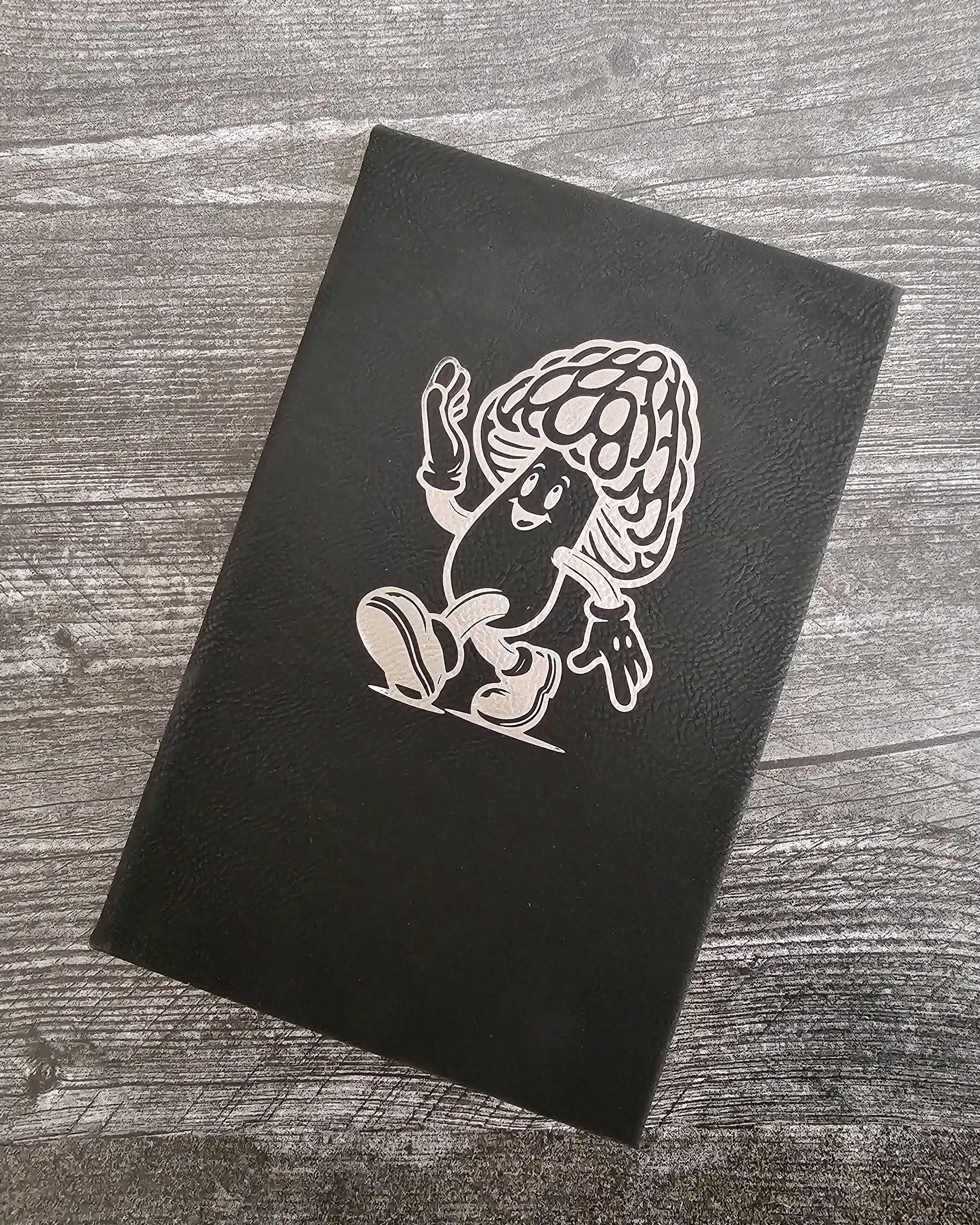 Personalized journal in black with silver engraved with fun cartoon mushroom guy design.