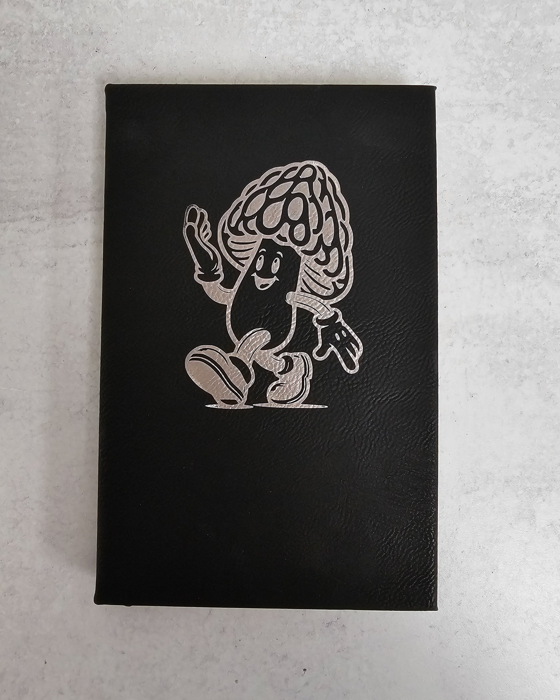 Personalized journal in black with silver engraved with fun cartoon mushroom guy design.