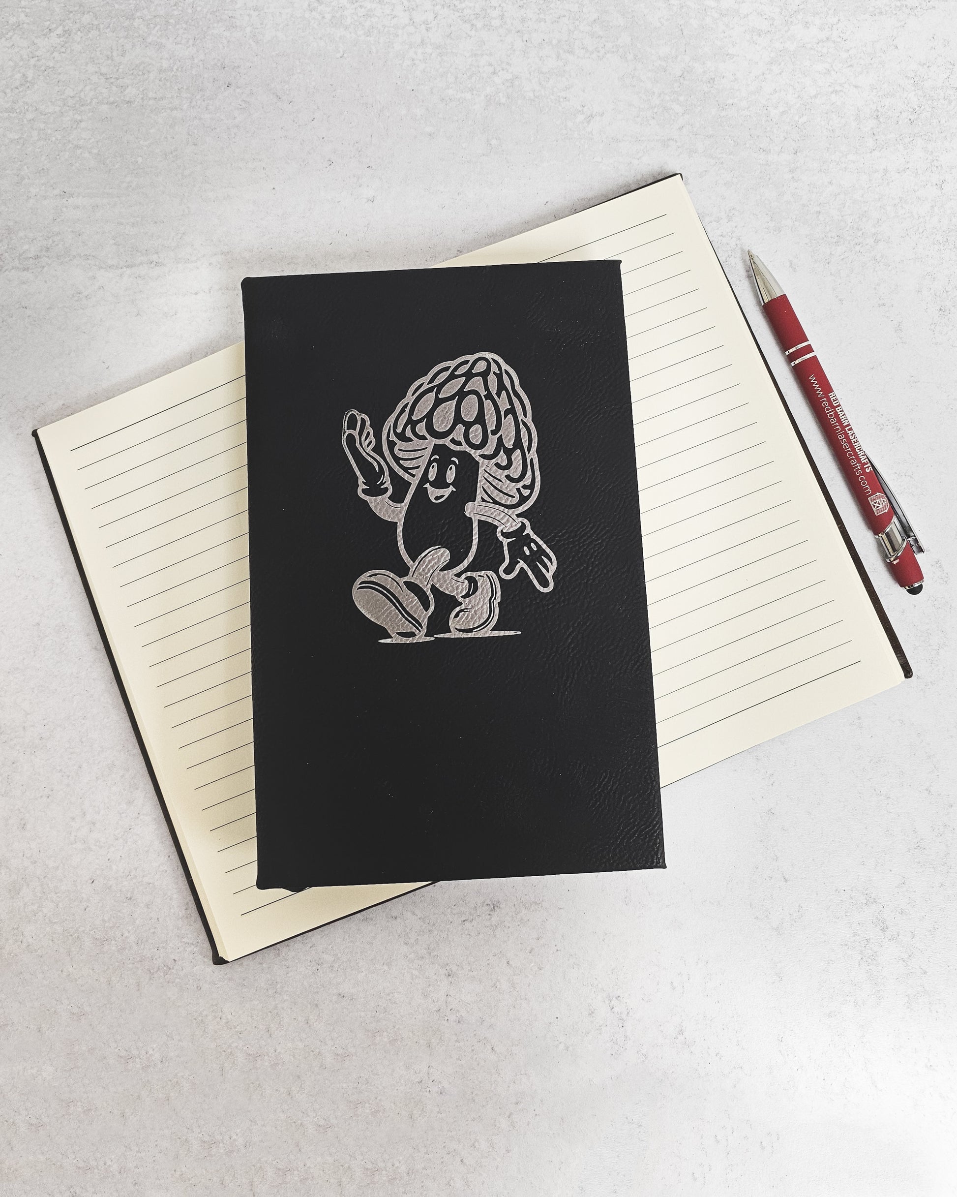 Personalized journal in black with silver engraved with fun cartoon mushroom guy design.