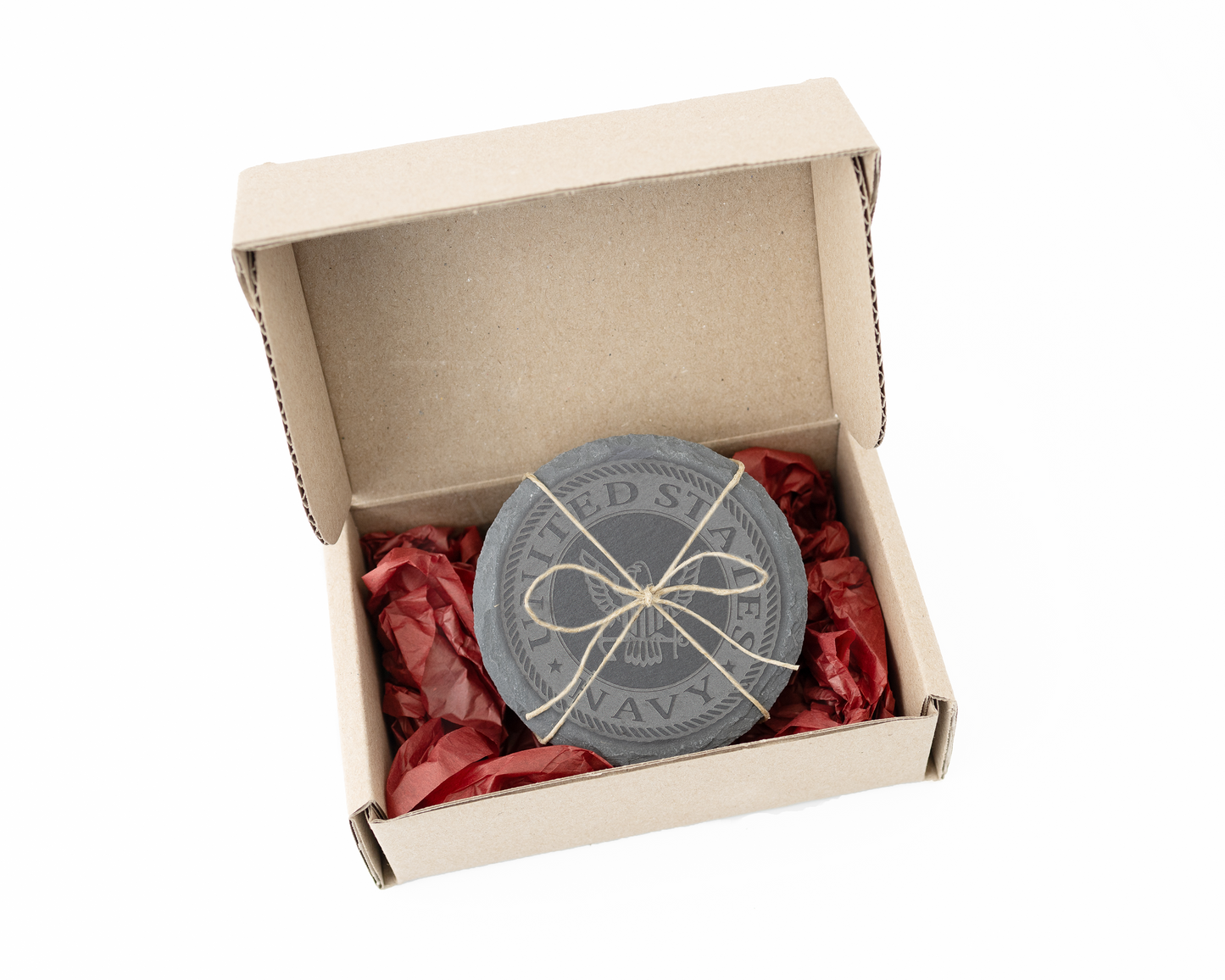Round slate coasters with string bow packaging in a cardboard box on a white background