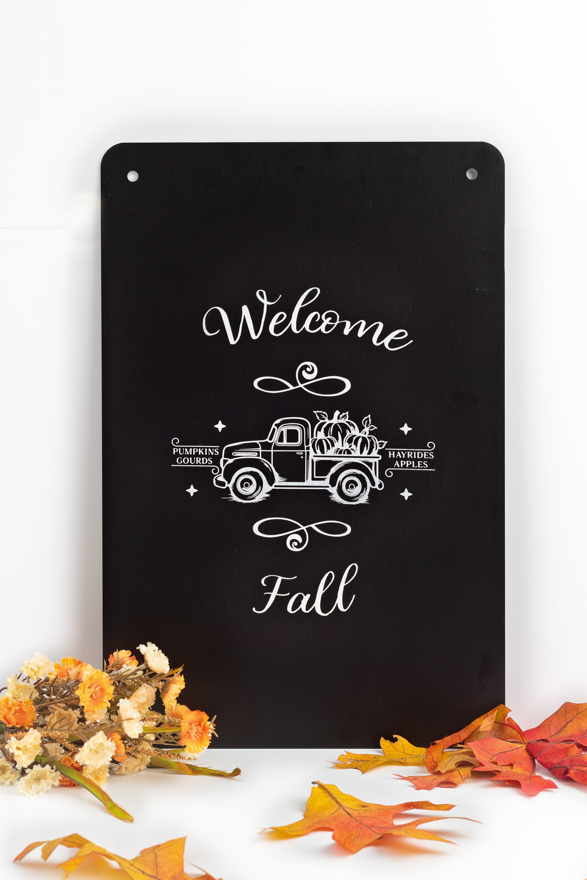 Decorative black sign with 'Welcome Fall' text and vintage truck design surrounded by autumn leaves and flowers.