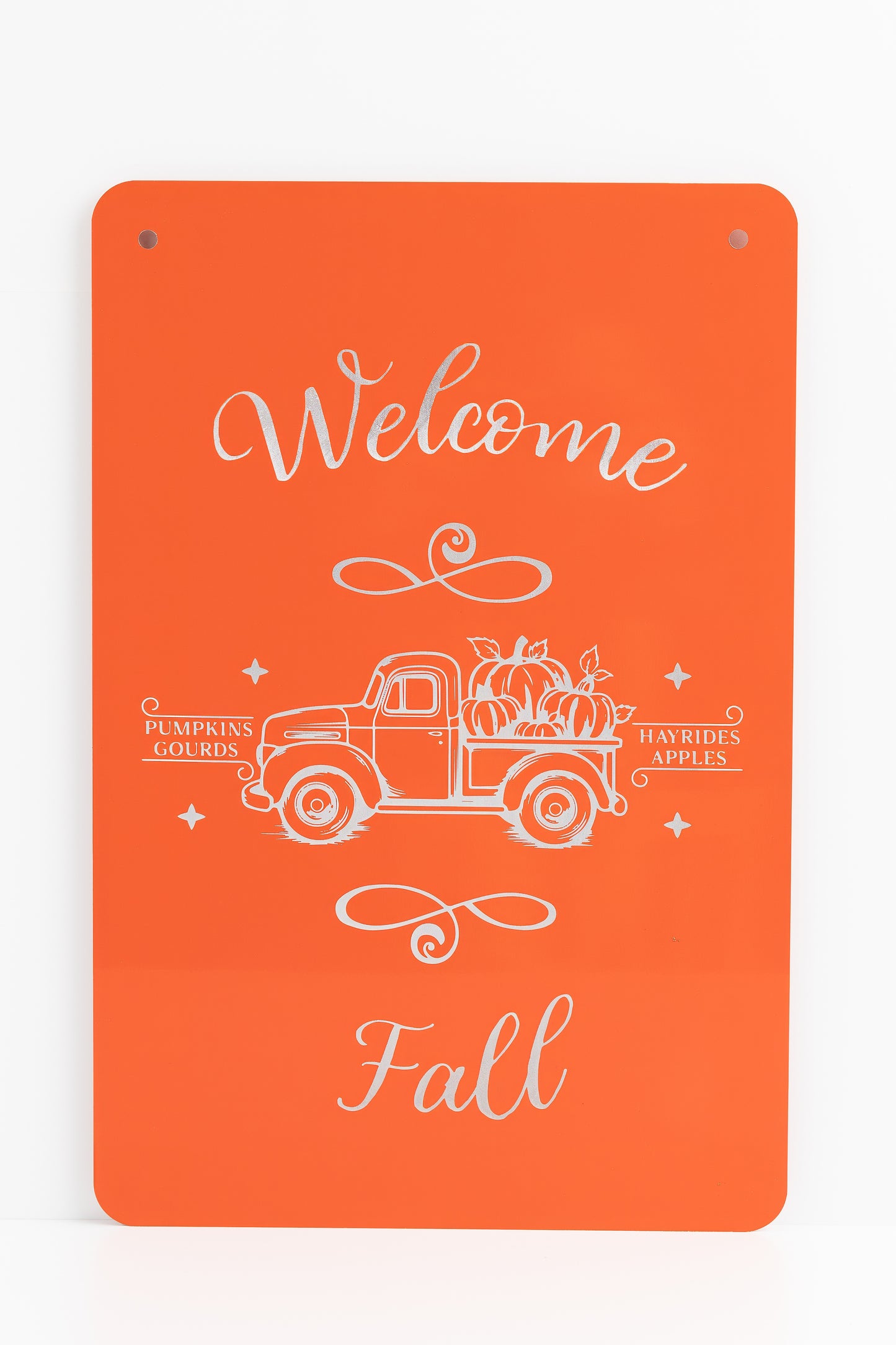 Orange sign with engraved text and truck graphic, featuring 'Welcome Fall' on a white background.