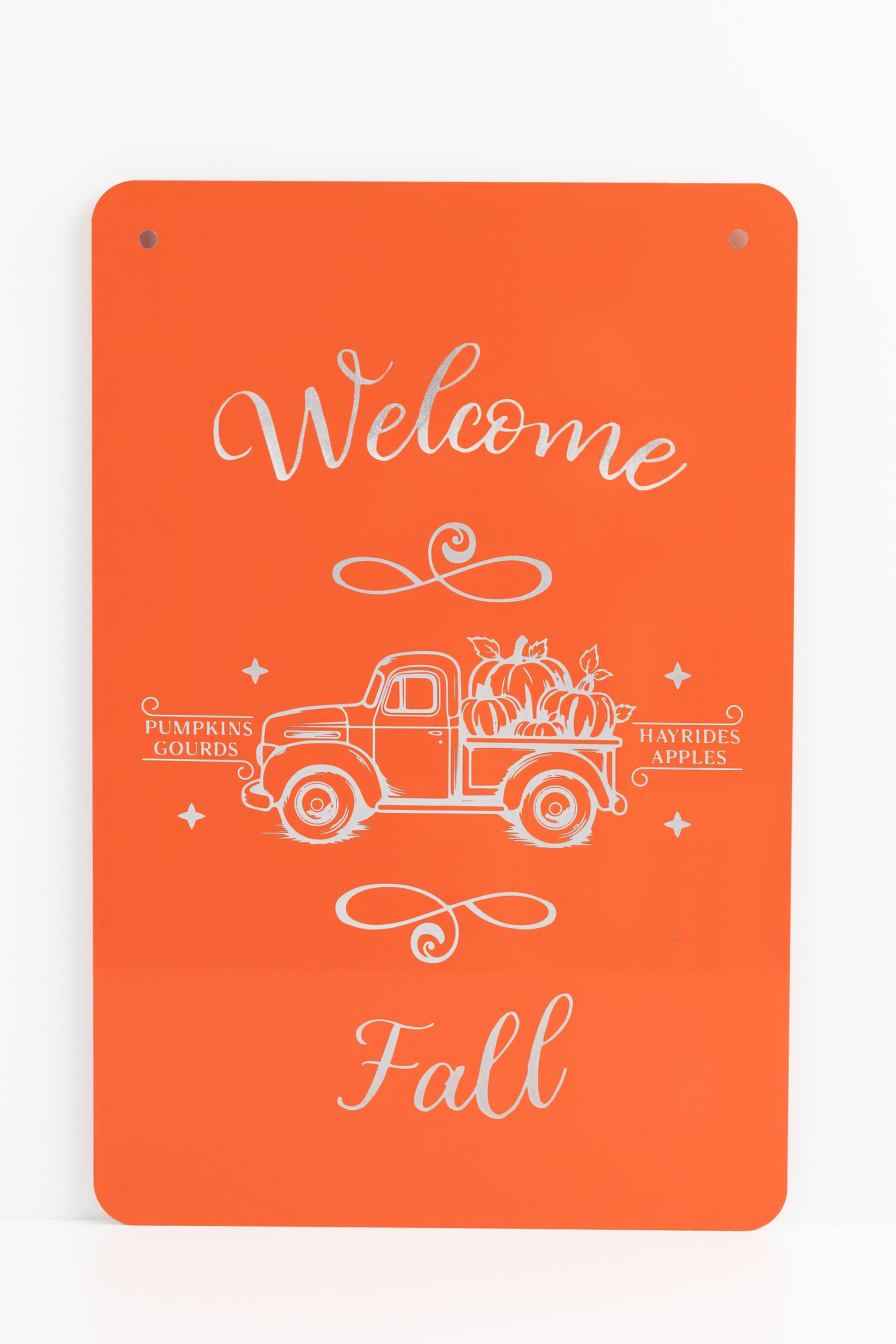 Orange sign with engraved text and truck graphic, featuring 'Welcome Fall' on a white background.