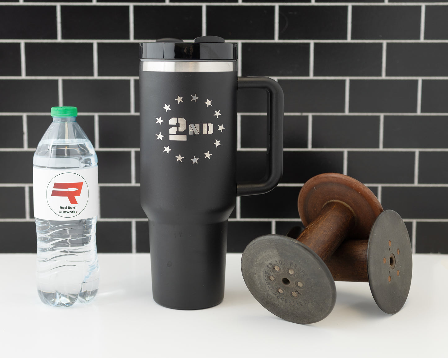 40oz tumbler in black with a 2nd Amendment design surrounded by stars. Shown with a water bottle for size comparison.