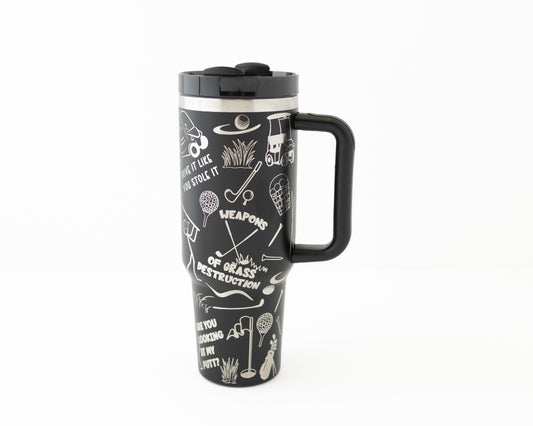 40 oz tumbler in black with golf sarcastic sayings and cartoon doodles wrapped around the tumbler. Back view.