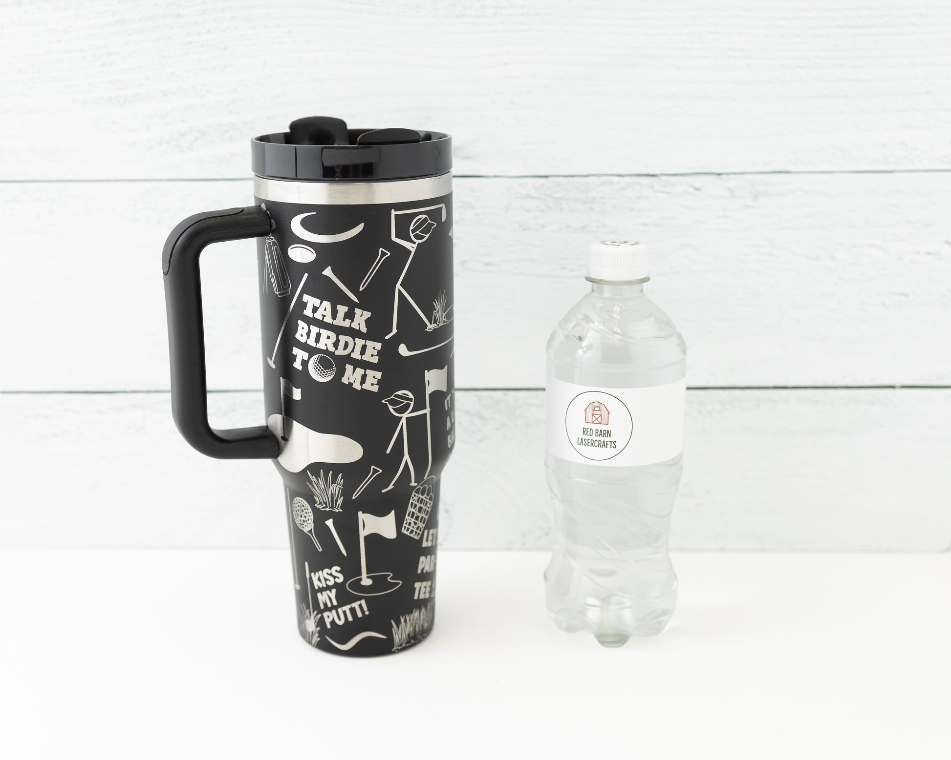 40 oz tumbler in black with golf funny sarcastic sayings and cartoon doodles wrapped around the tumbler. Front view next to a water bottle for size comparison.