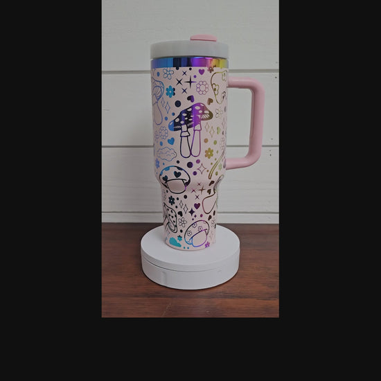 40oz tumbler in pink and rainbow with magic mushroom wrap design. 