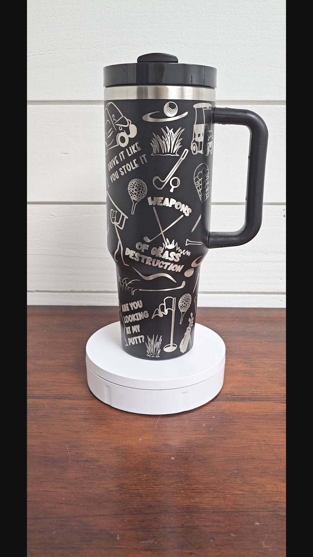 40 oz tumbler in black with golf sarcastic sayings and cartoon doodles wrapped around the tumbler. 